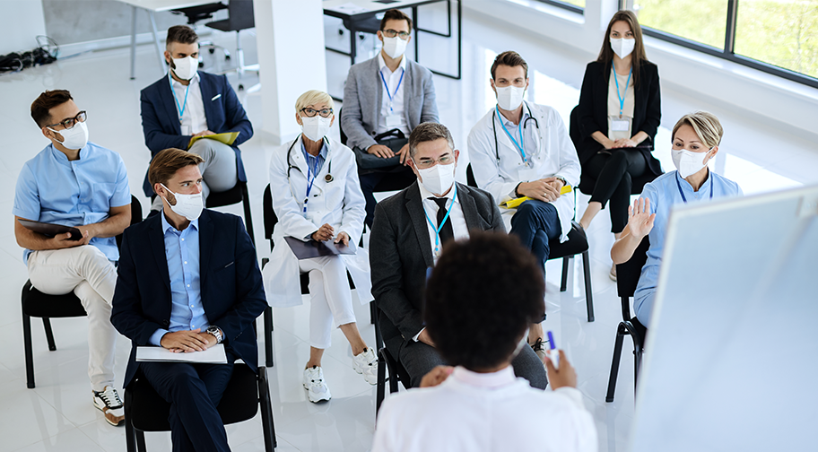 staff in a meeting wearing masks